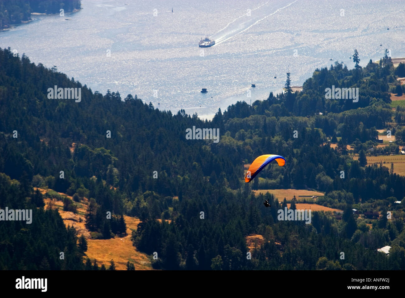 Paraglider flying over salt spring. Fulford Harbour and BC Ferry in the