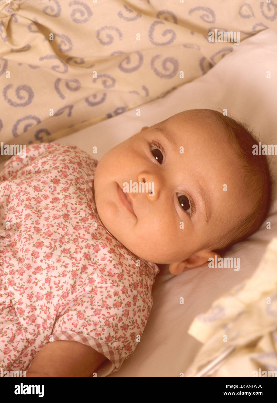 Baby girl awake in her crib looking up Stock Photo Alamy