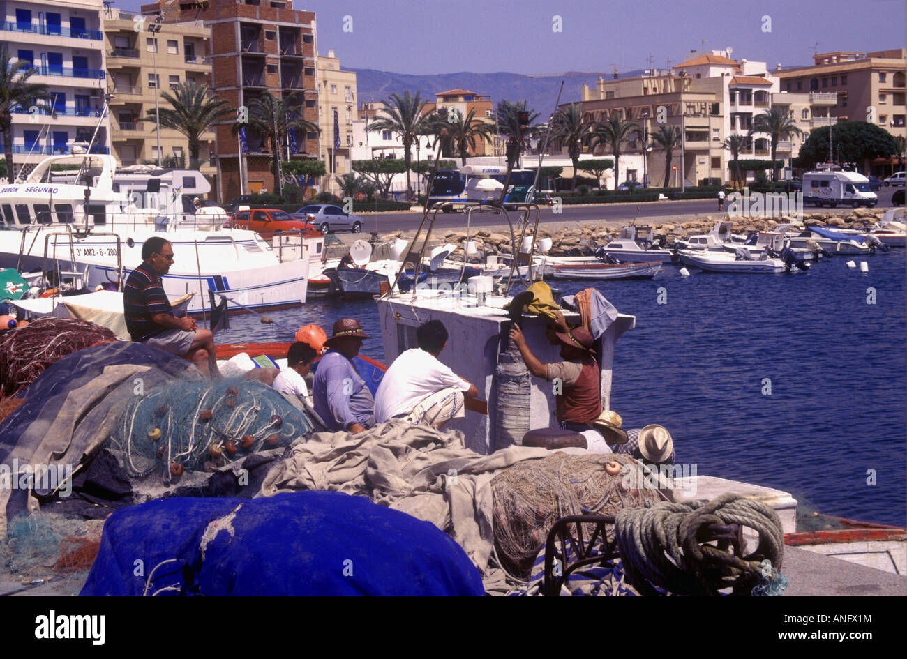 Fishermen on the harbour quayside in the resort of Roquetas de Mar  on the Costa Almeria Stock Photo