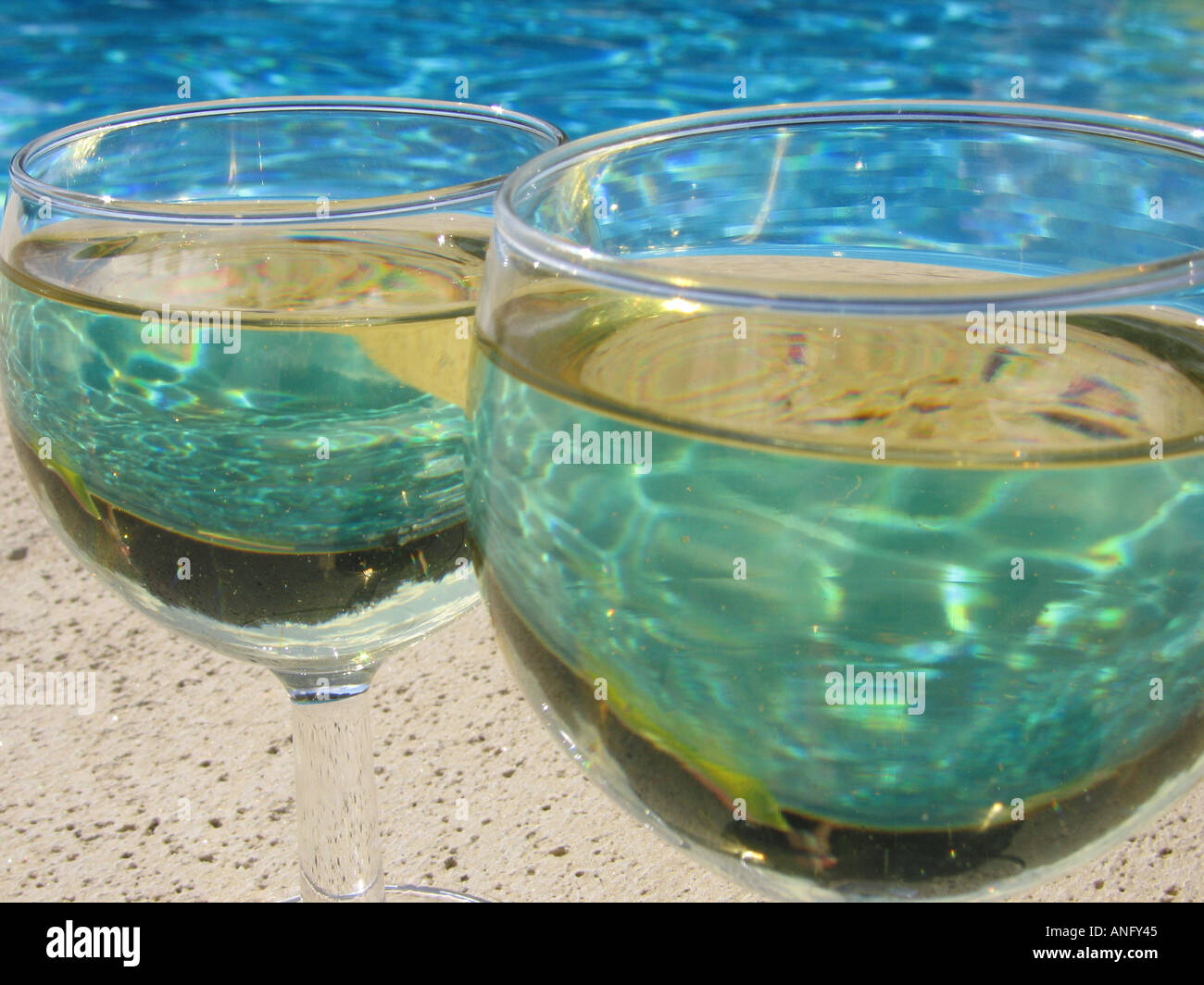2 wine glasses by poolside Stock Photo Alamy