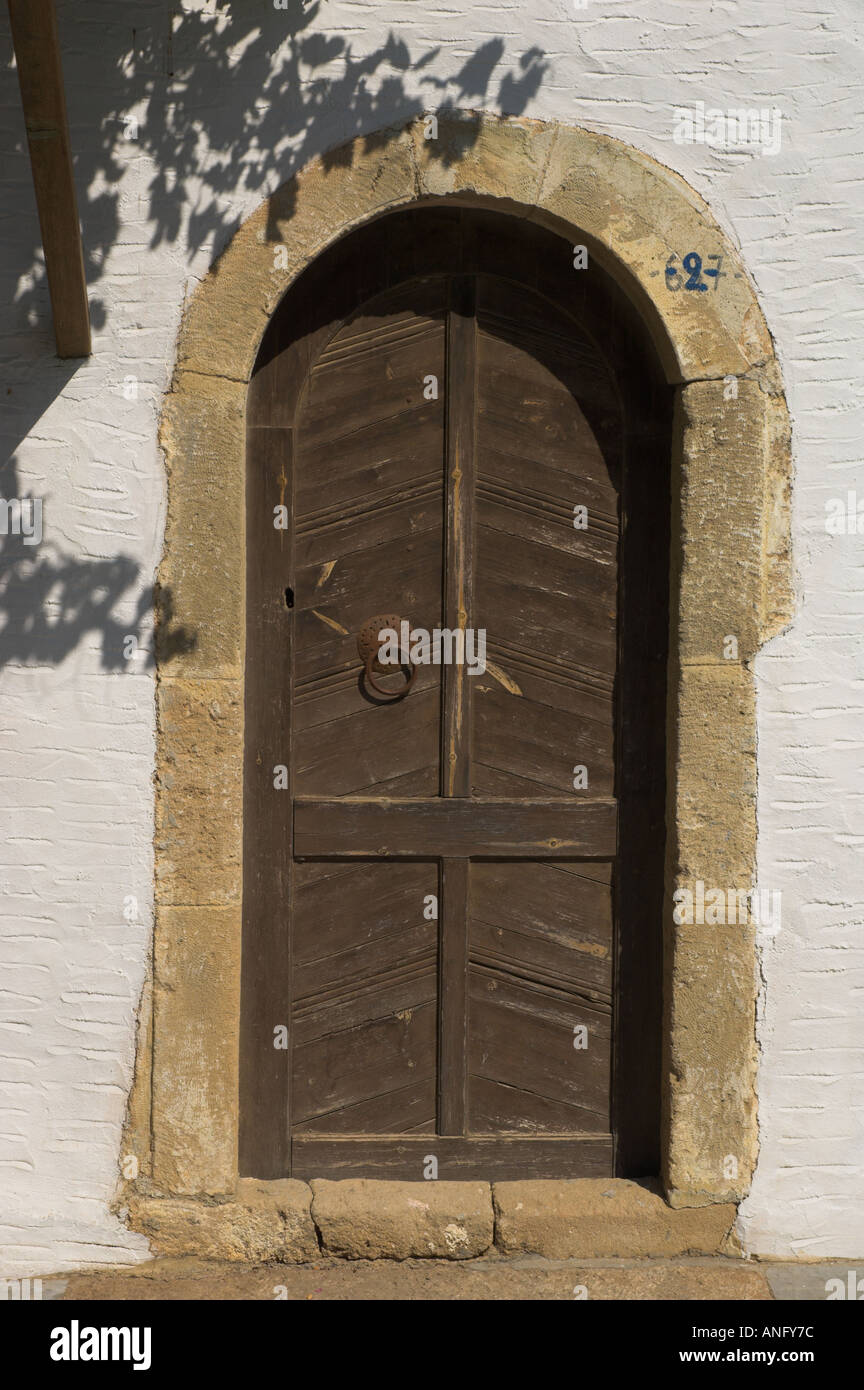 Greece Crete East Coast Palekastro area monastery of Moni Toplou ancient door with wine shadows and white wall Stock Photo