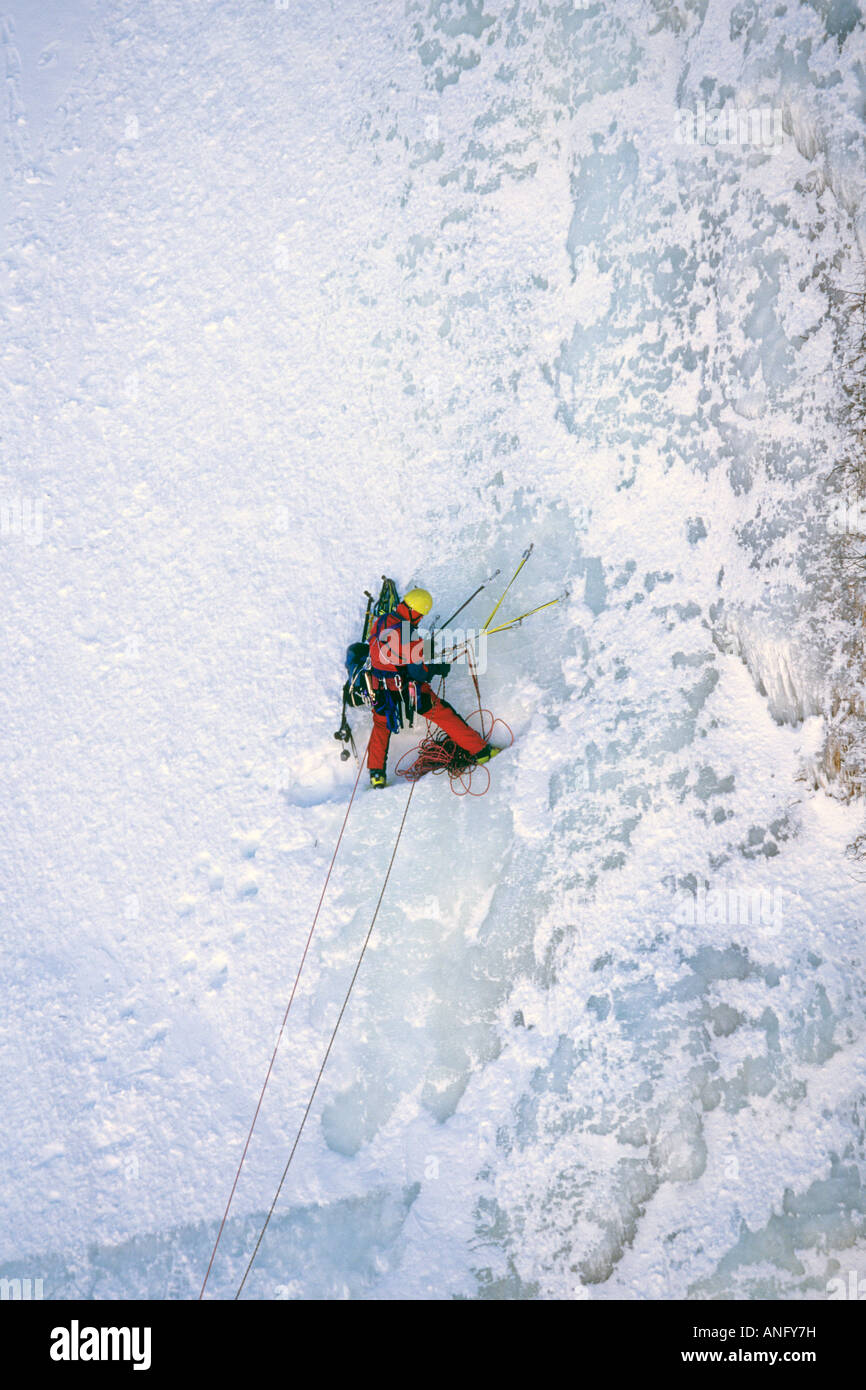 Ice Climber scaling iced wall of Baker's Brook Pond, Gros Morne National Park, Newfoundland, Canada. Stock Photo