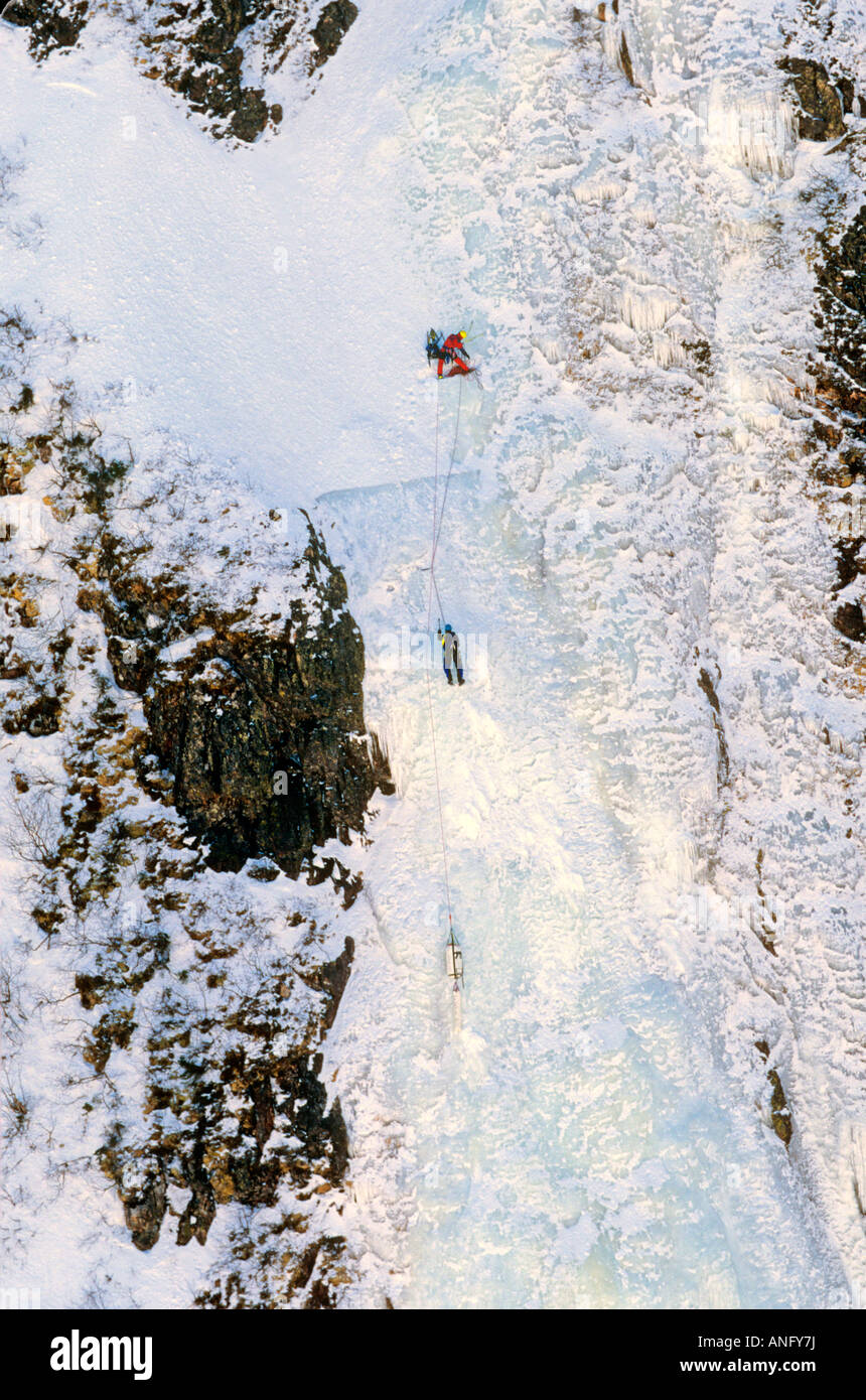 Ice Climbers scaling iced wall of Baker's Brook Pond, Gros Morne National Park, UNESCO, World Heritage Site, Newfoundland, Canad Stock Photo