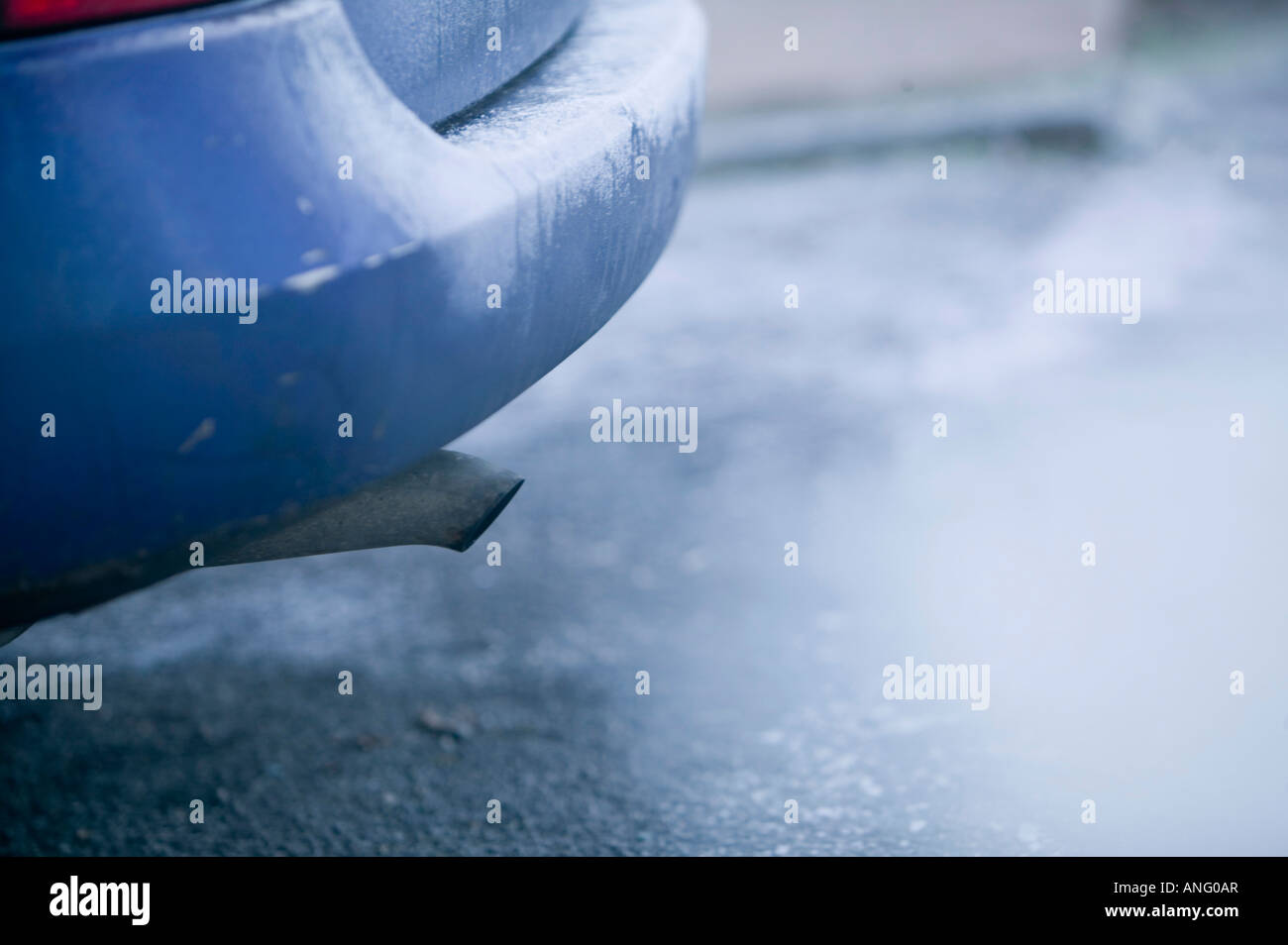 A car exhaust pipe emmitting exhaust fumes Stock Photo