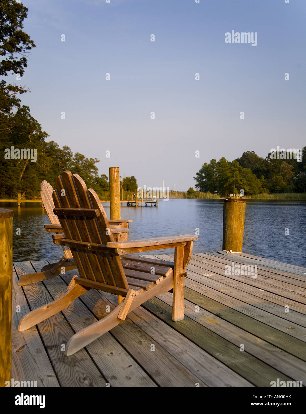Two adirondack chairs on a dock Stock Photo Alamy