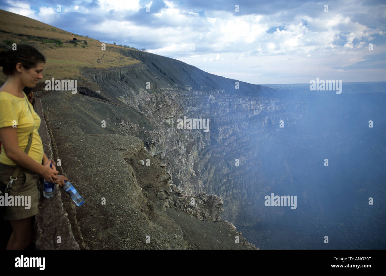 Masaya volcano, Nicaragua. Tourist gazing at the steaming gasses from viewpoint Stock Photo