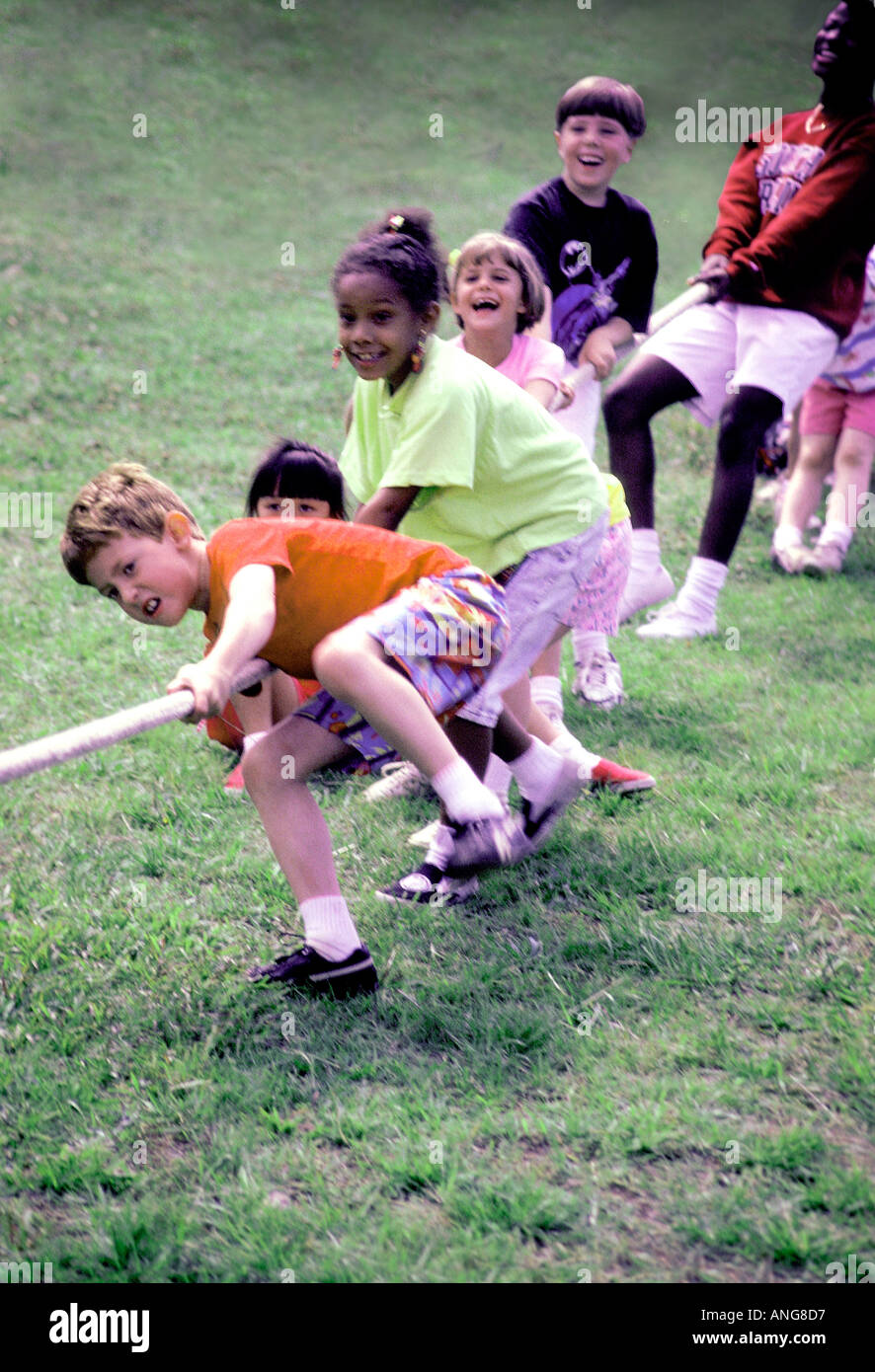 Tug of war Diverse group of school children playing tug of war Stock Photo