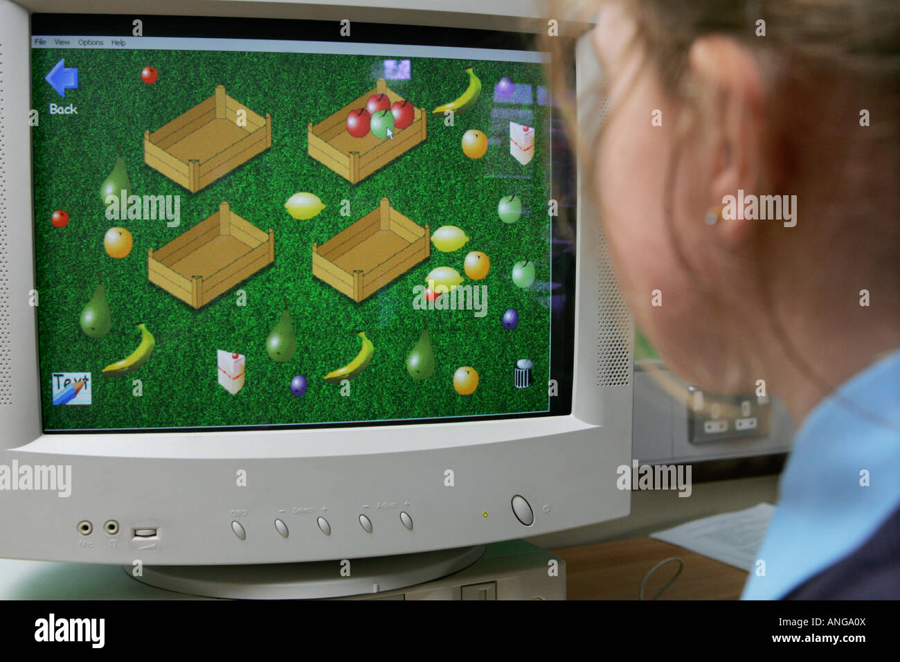 Child using interactive program on school computer Stock Photo