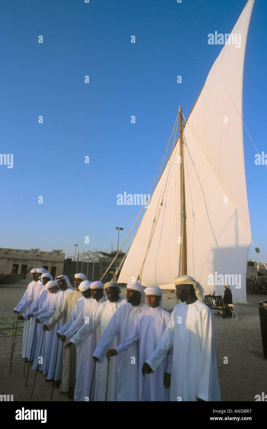 United Arab Emirates Dubai group of men singing at sunset Stock Photo
