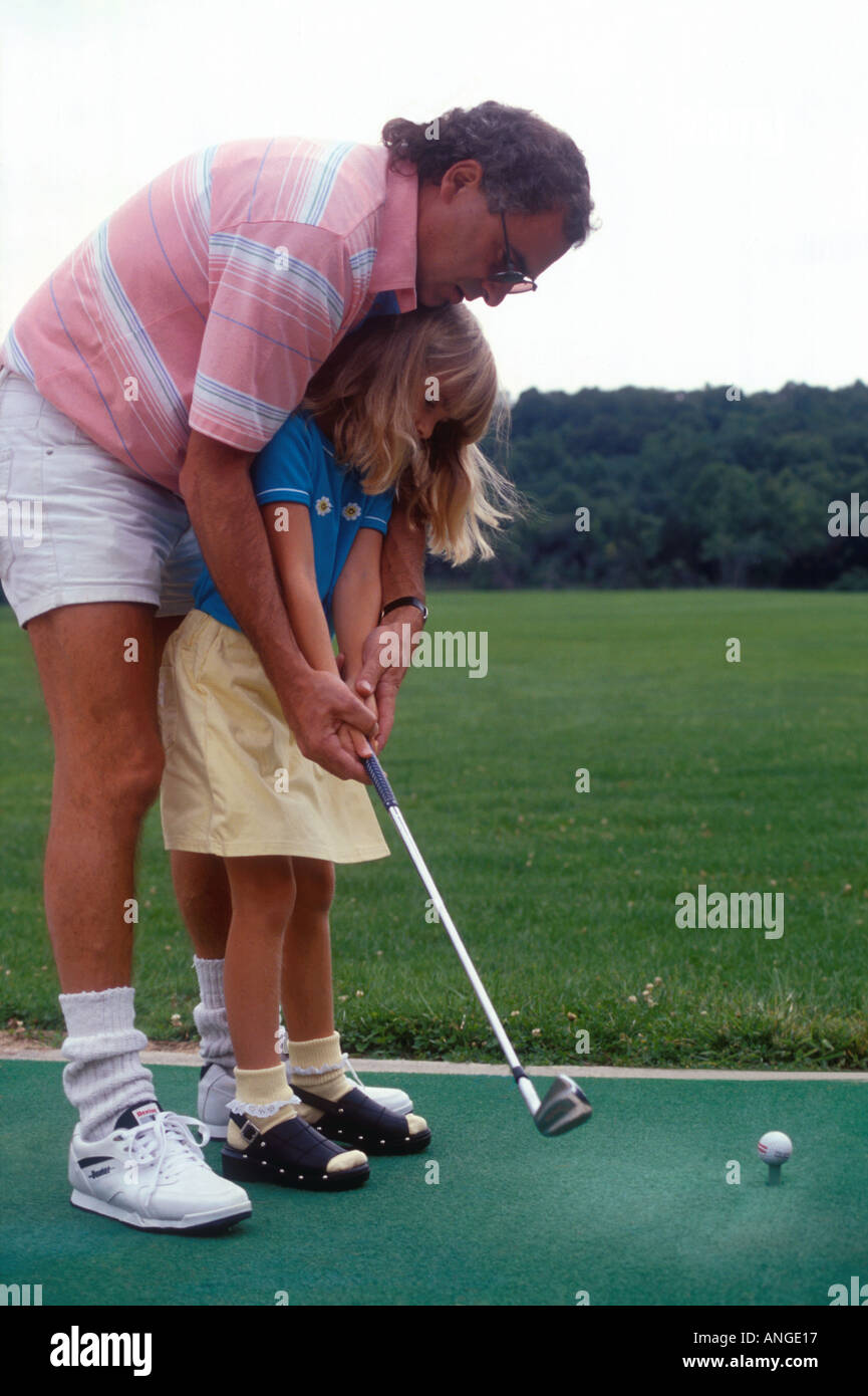 Dad teaching Daughter Golf Stock Photo - Alamy