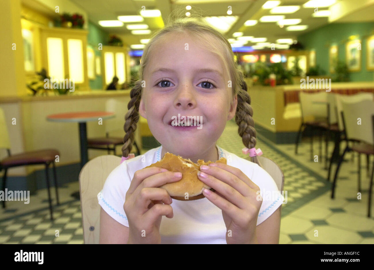 Young girl eats a burger UK Stock Photo - Alamy