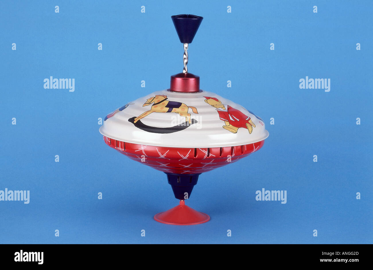 Vintage toy spinning top on blue background Stock Photo