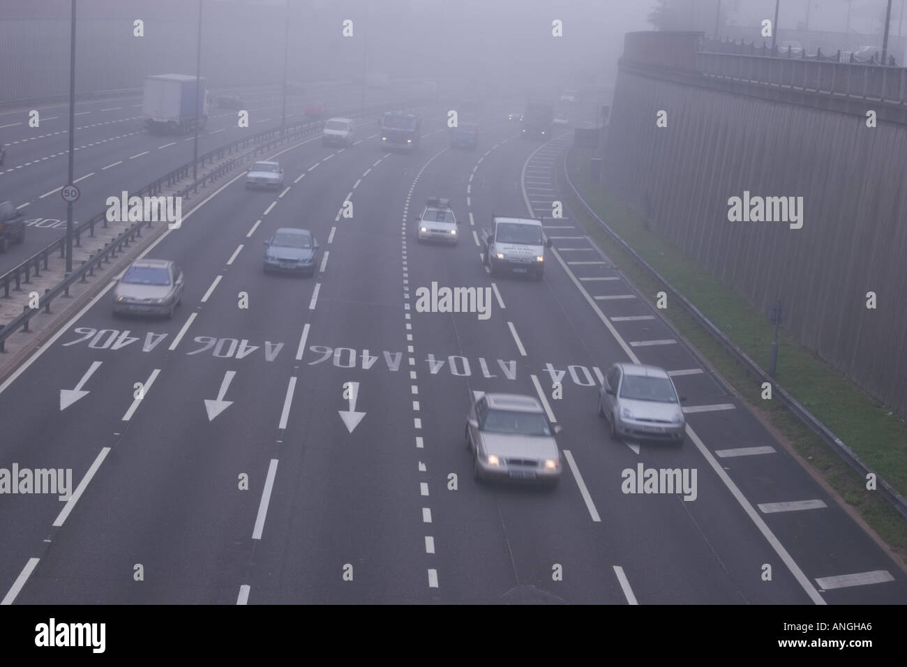 traffic in the fog motorway traffic on the six lane A406 in foggy traffic conditions Stock Photo