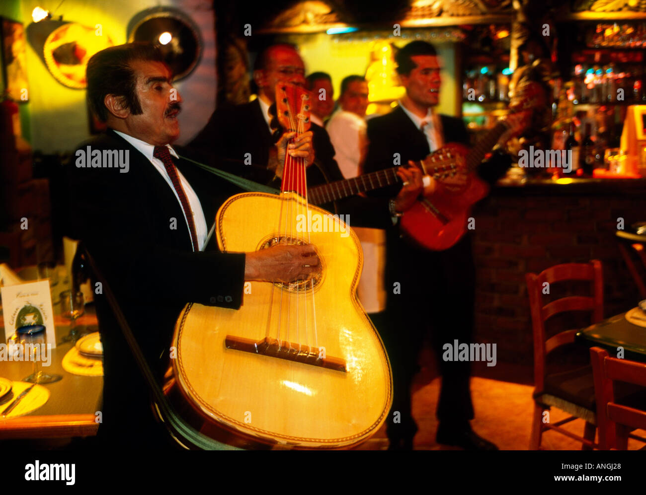 Musicians playing guitar in a restaurant bar in Mexico Stock Photo