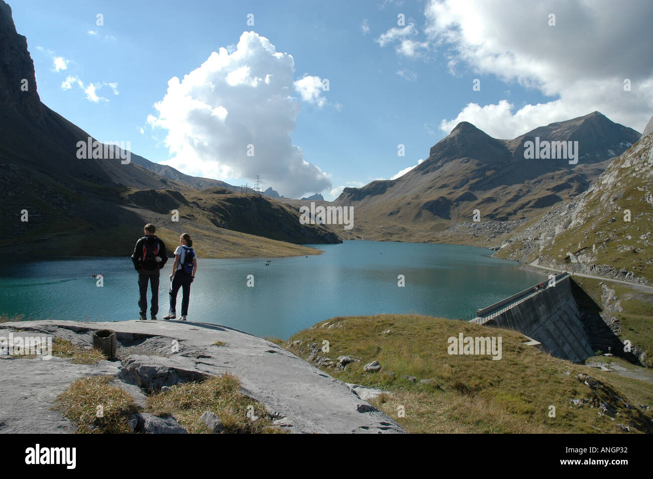 hikers-at-sanetsch-lake-hydroelectric-dam-swiss-alps-valais-switzerland