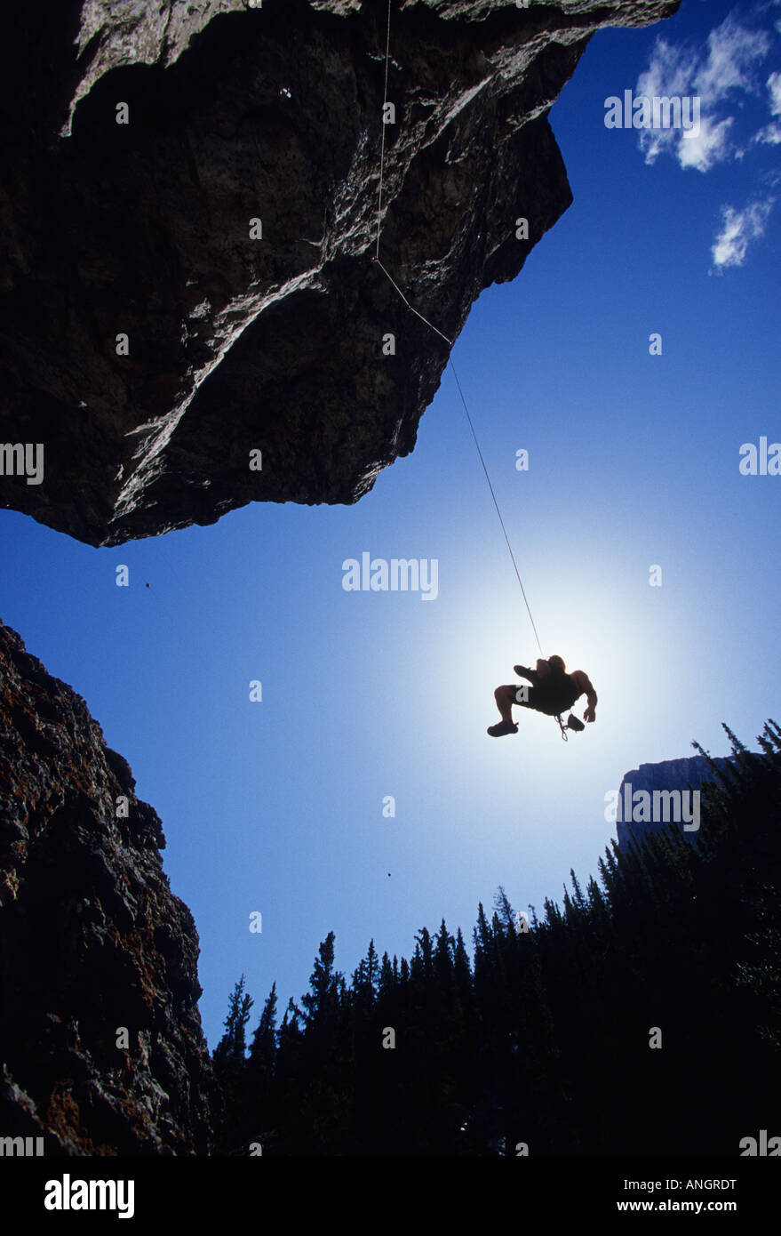 A young man being lowered after he leads, Grassi Lakes, Canmore, Alberta, Canada. Stock Photo