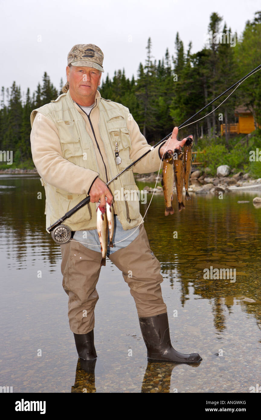 Fisherman with a catch of Speckled Trout, caught near Tuckamore Lodge, Main Brook, Viking Trail, Great Northern Peninsula, Newfo Stock Photo
