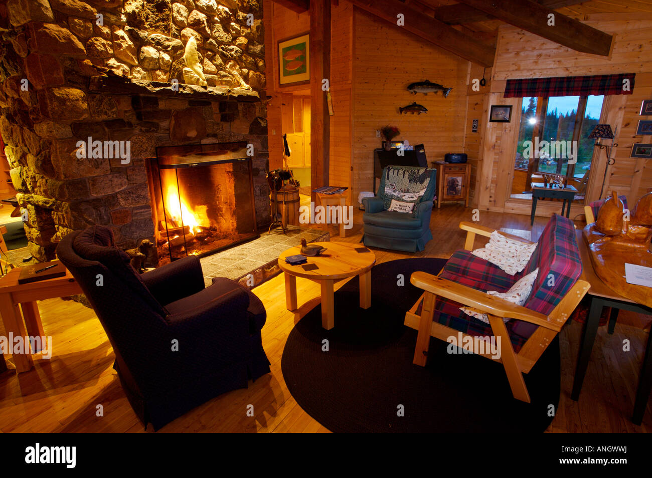 Lounge room with open fire at the Rifflin'Hitch Lodge in Southern Labrador, Newfoundland & Labrador, Canada. Stock Photo