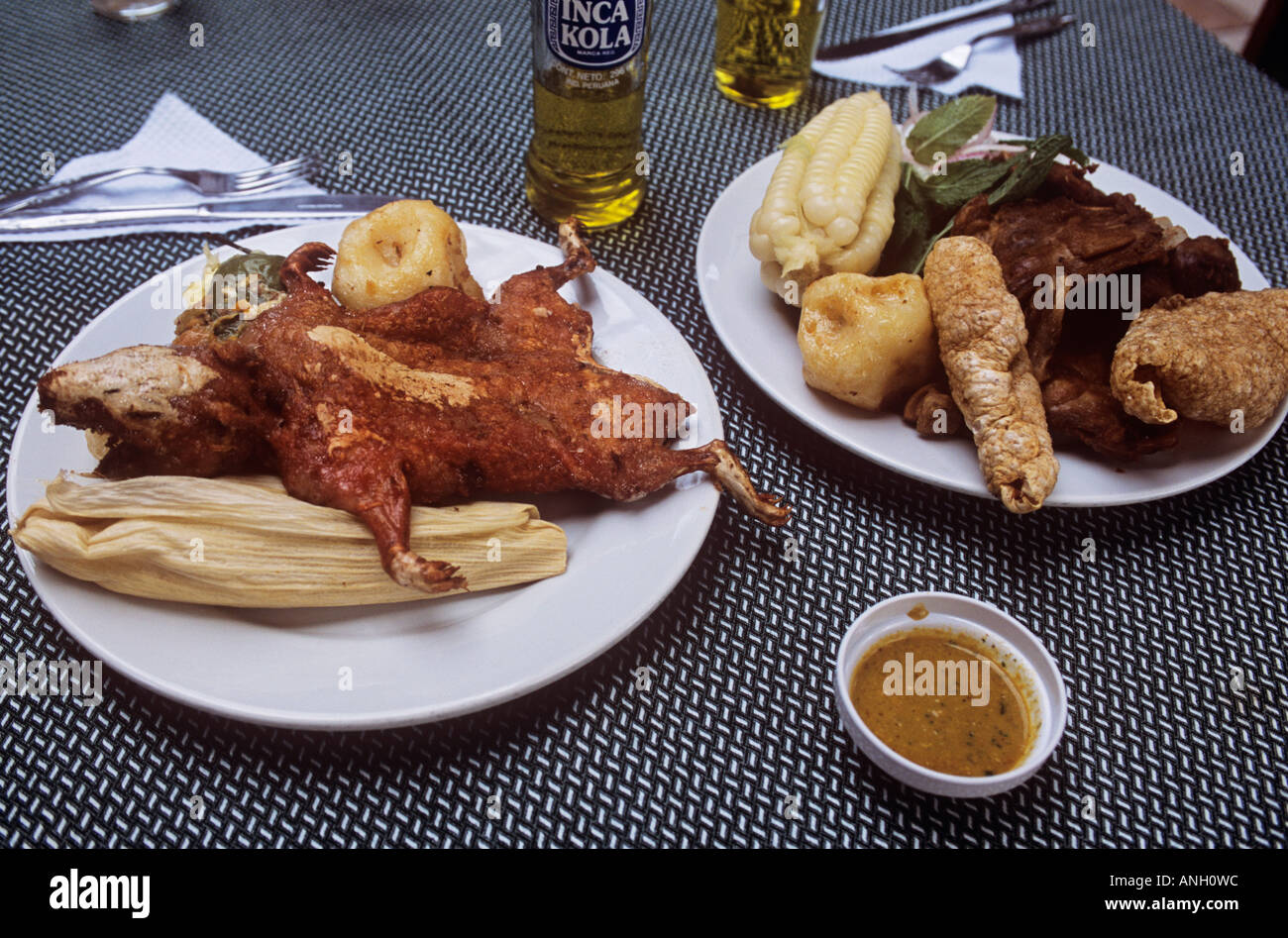 Popular dishes in Peruvian cuisine include cuy choctado or guinea pig left and chicharron crispy pork with crackling right Stock Photo Alamy