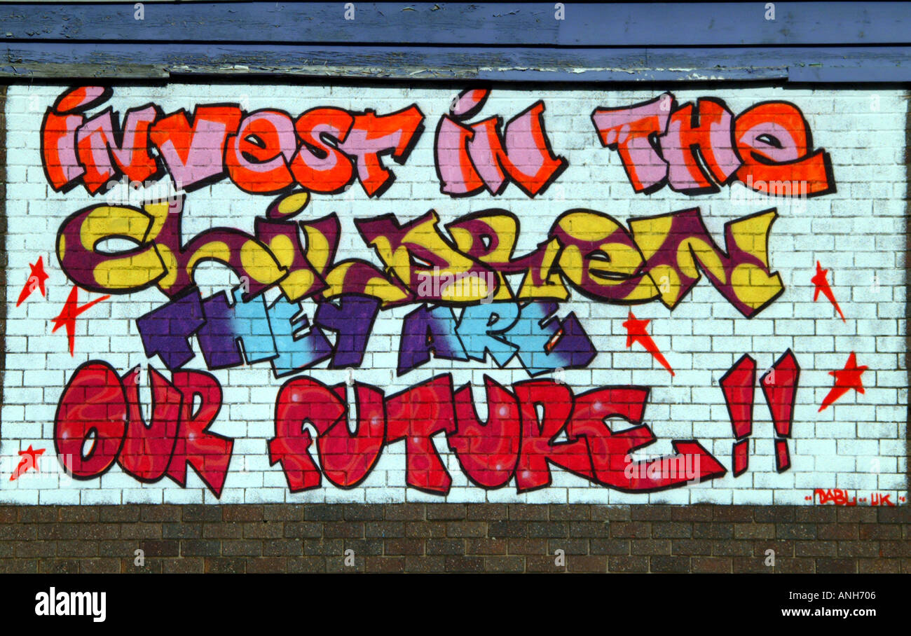 Graffiti wall art Invest in the children they are our future Hulme Manchester North West UK Europe Stock Photo