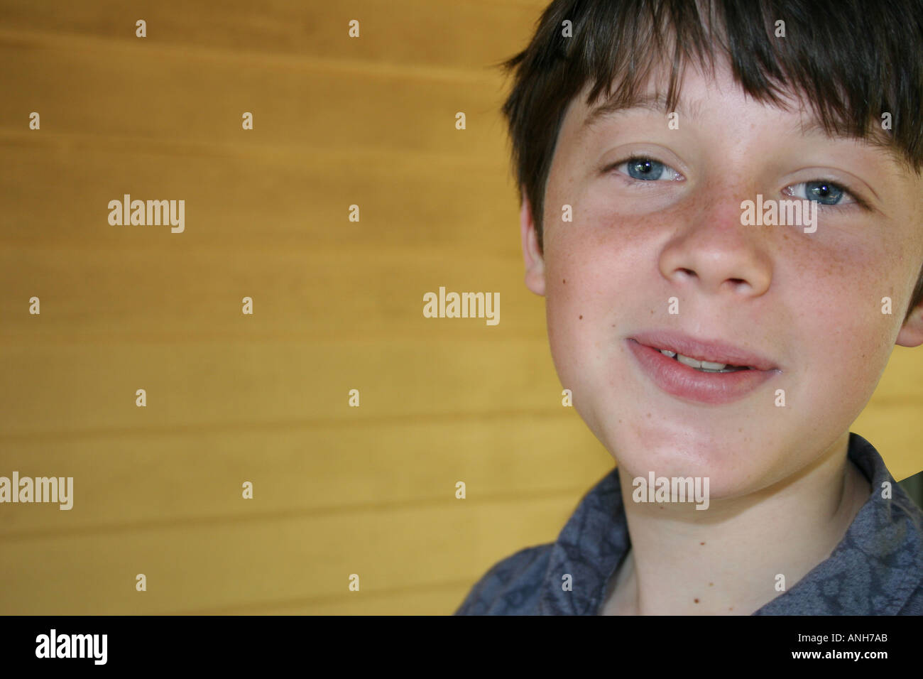 Expressive young boy shows a warm and wry smile Stock Photo