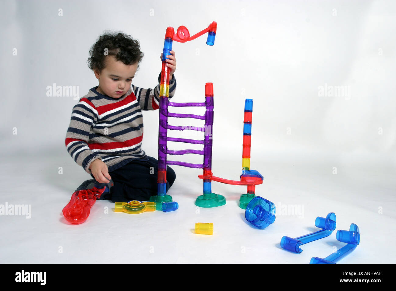 Pvc Marble Ramp A small boy constructs an elaborate series of plastic ramps on which to ...