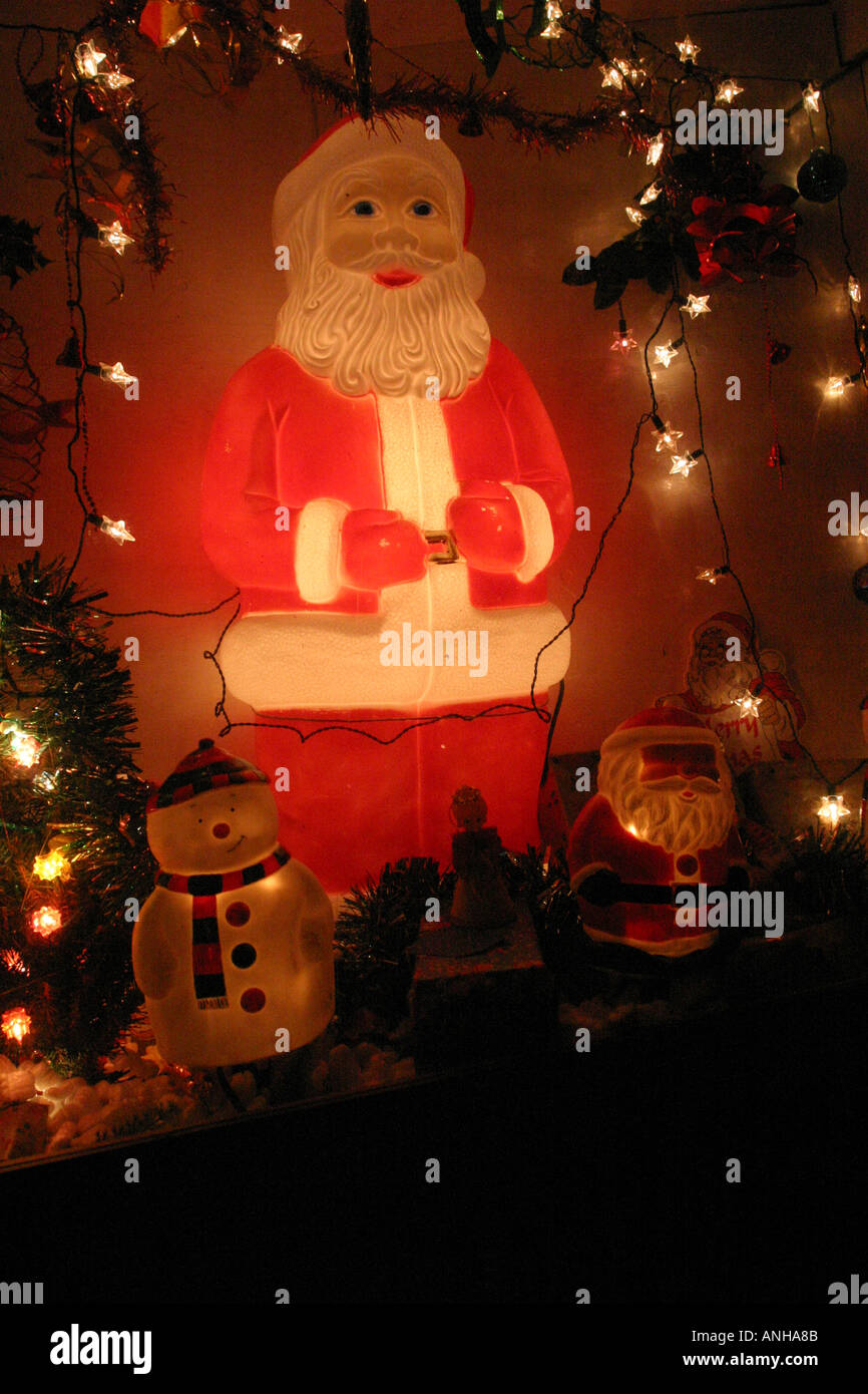 Illuminated Father Christmas doll and fairy lights Stock Photo Alamy