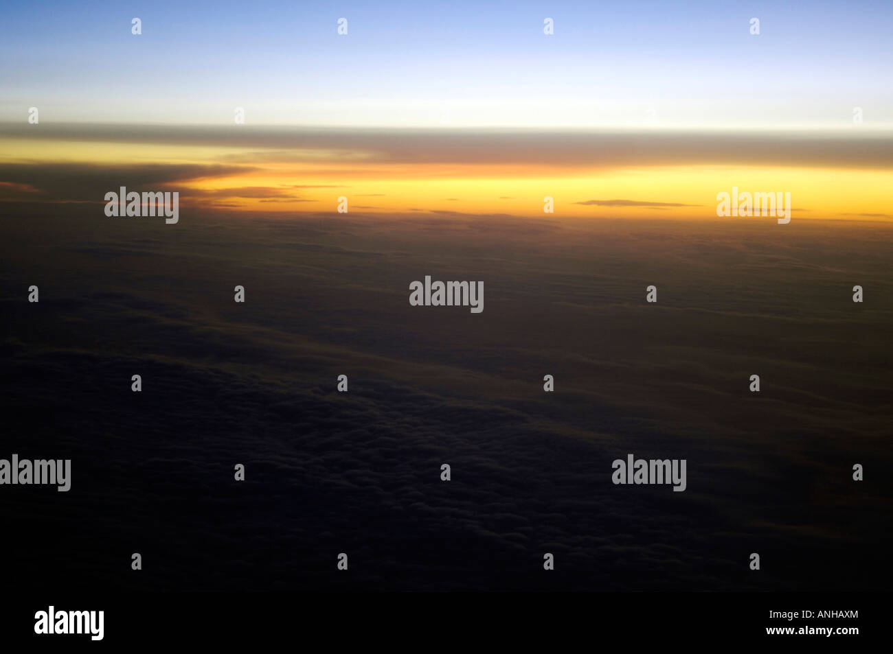 above the clouds sunset dusk from aeroplane in flight end of the day ...