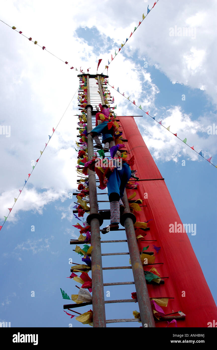 China Yunnan Baoshan lisu minority festival people climb knife Stock Photo