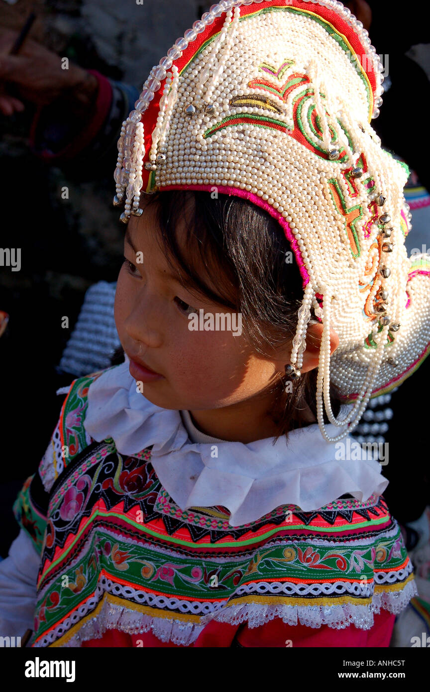 a girl have Yunnan Hani minority traditional clothes go to festival. Stock Photo