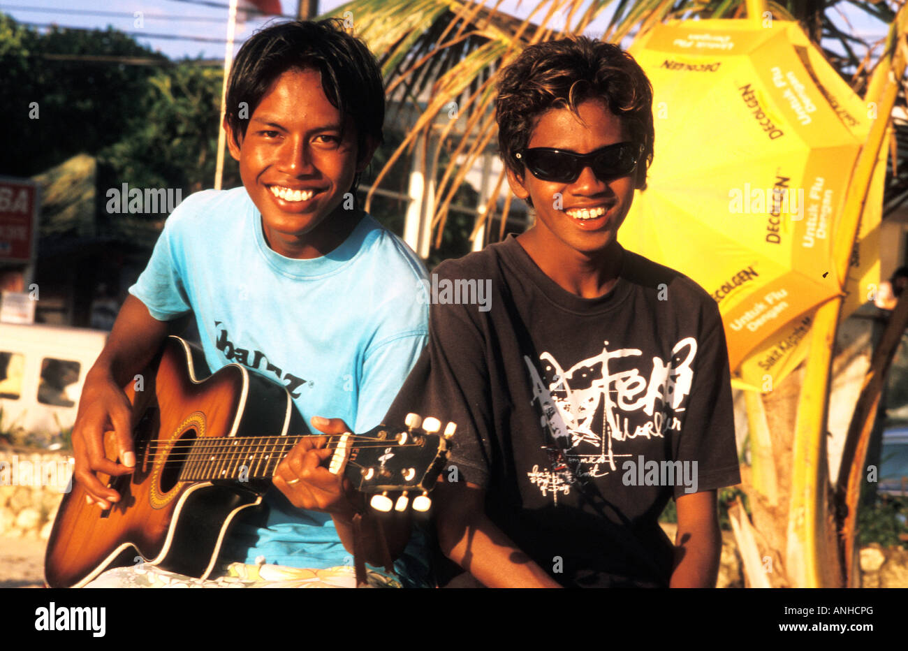 beach touts playing music, kuta beach, bali, indonesia Stock Photo