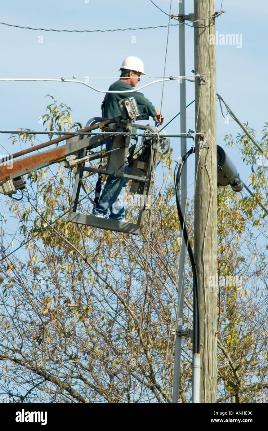 Telephone worker repairs line on pole Stock Photo Alamy