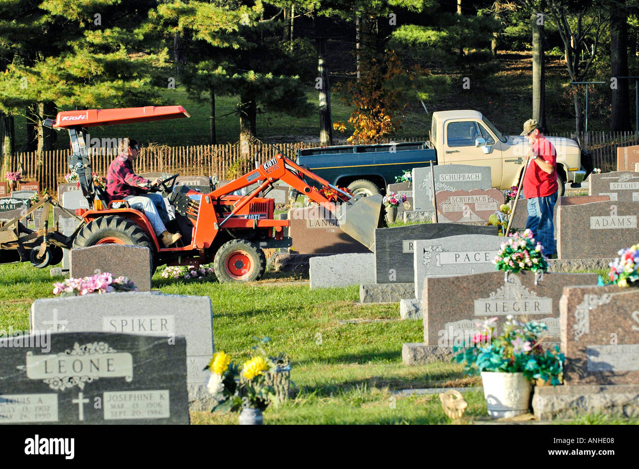 Workers cover a casket with dirt in a cemetery Stock Photo Alamy