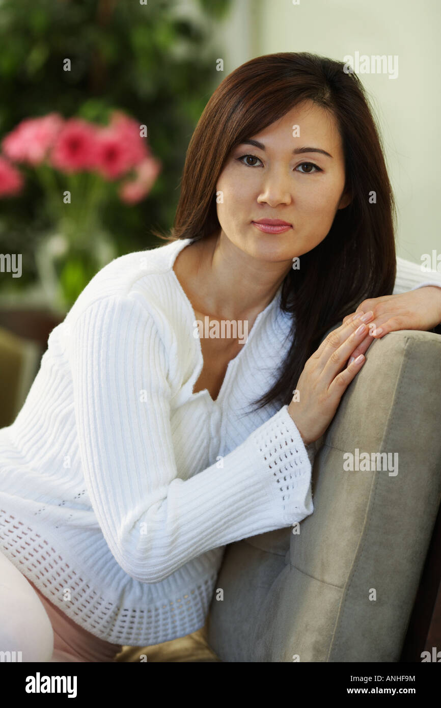 Asian woman sitting on chair Stock Photo - Alamy