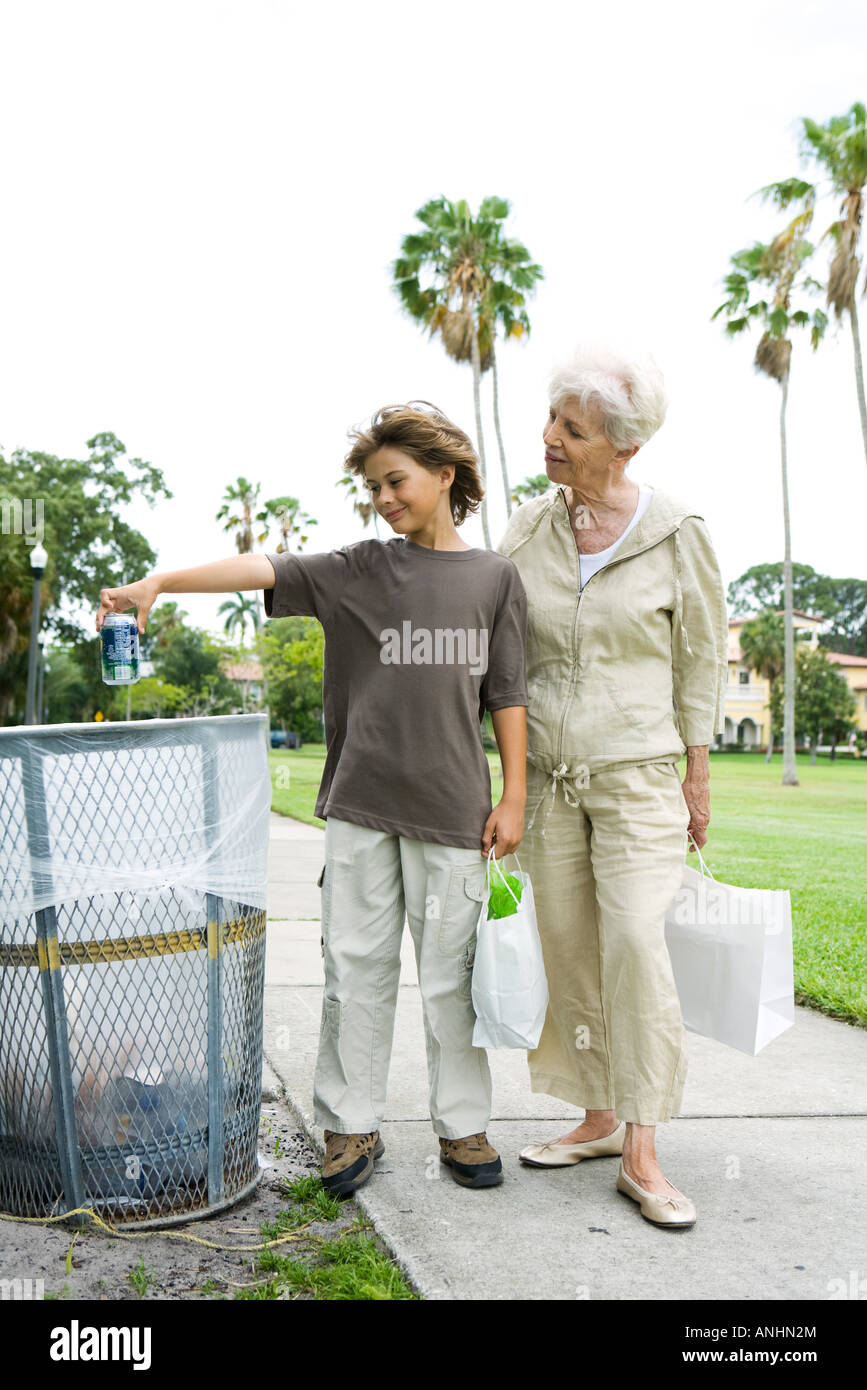 Boy throwing garbage into trash can hires stock photography and images