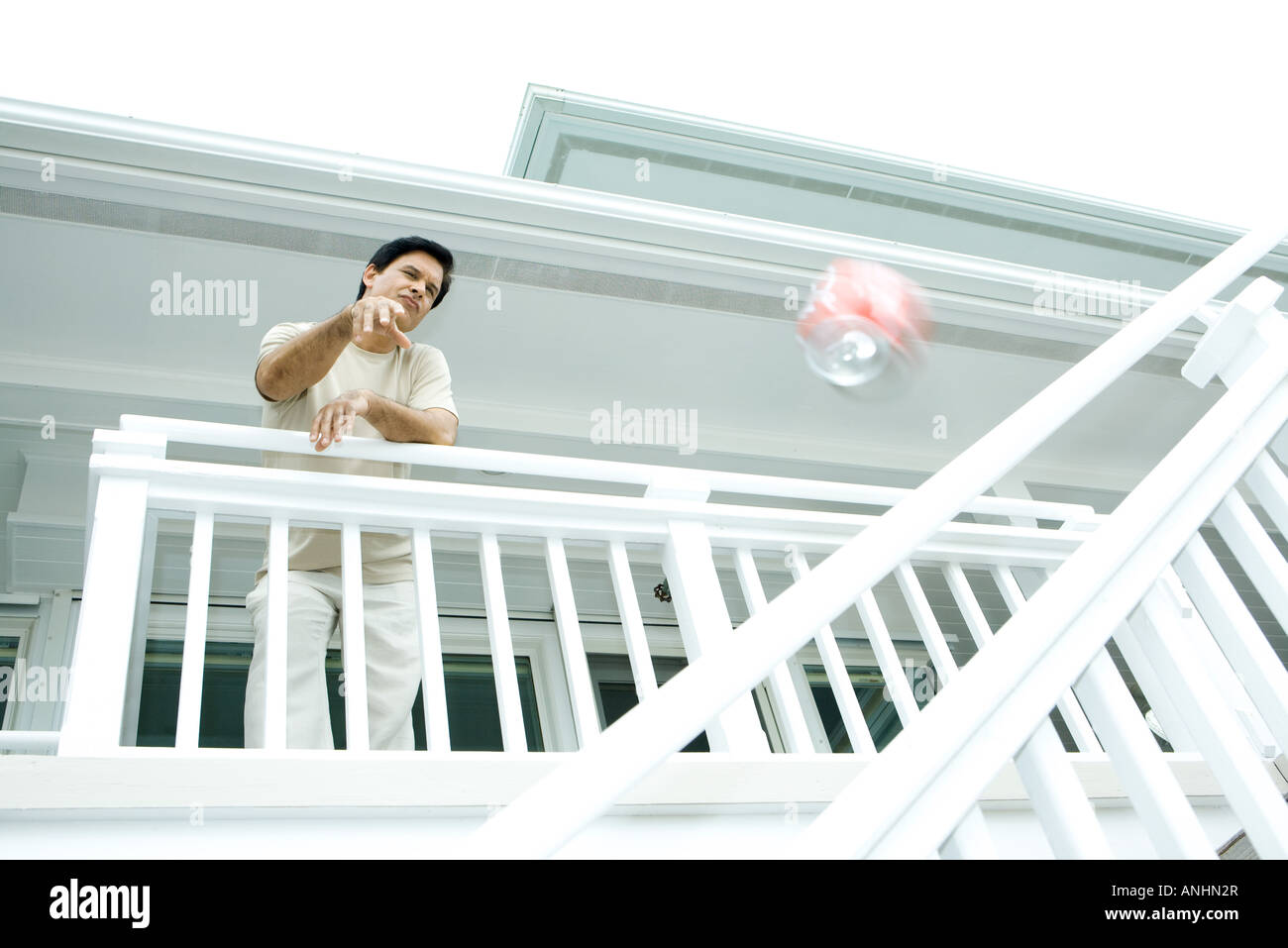 Man throwing drink can from deck, low angle view Stock Photo Alamy