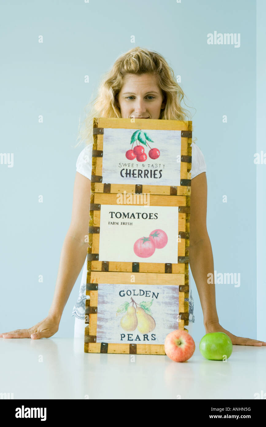 Woman standing behind crates of produce Stock Photo - Alamy