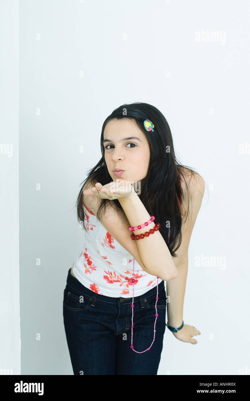 Teen girl blowing a kiss at camera, portrait Stock Photo - Alamy