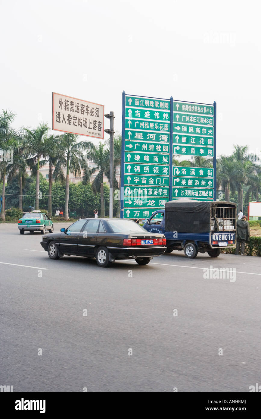 China, cars turning by directional signs Stock Photo