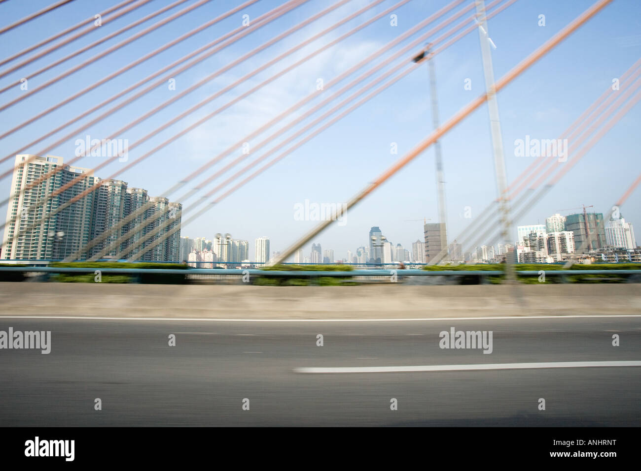Suspension bridge, cropped view, cityscape in background Stock Photo