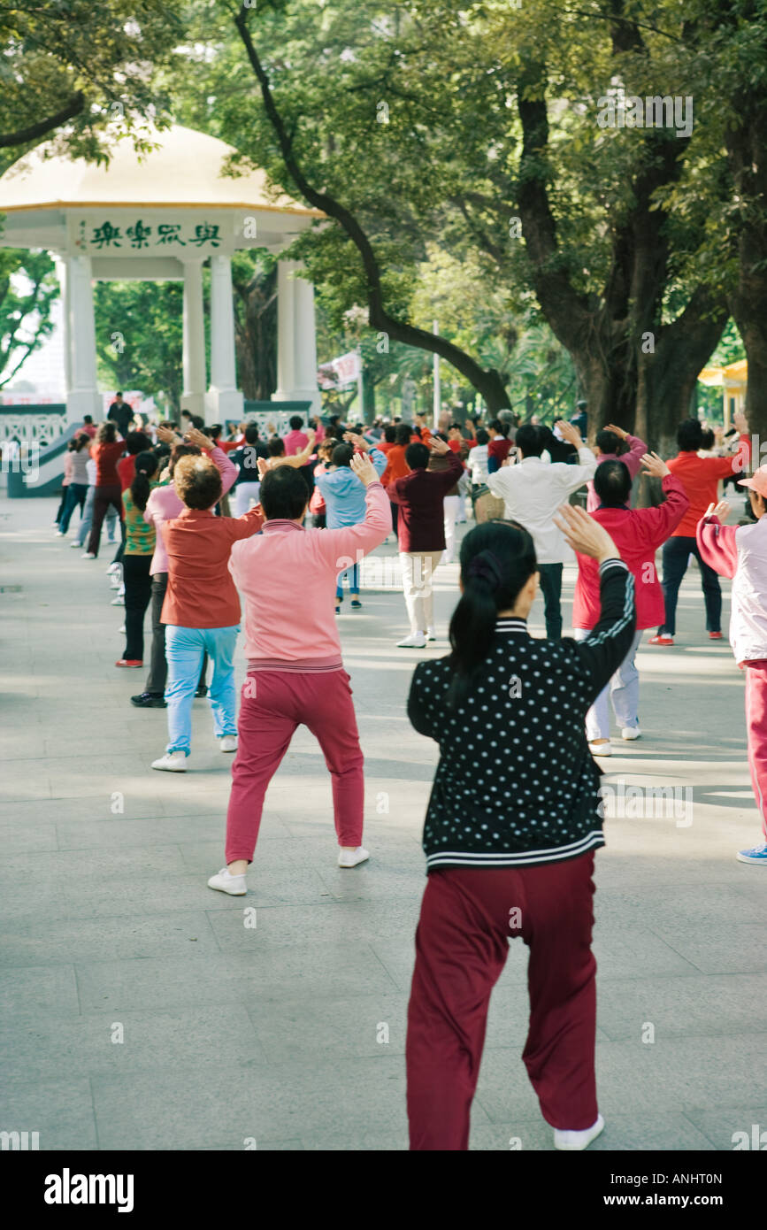 China, large group of adults doing Tai Chi Chuan in city square, rear view Stock Photo