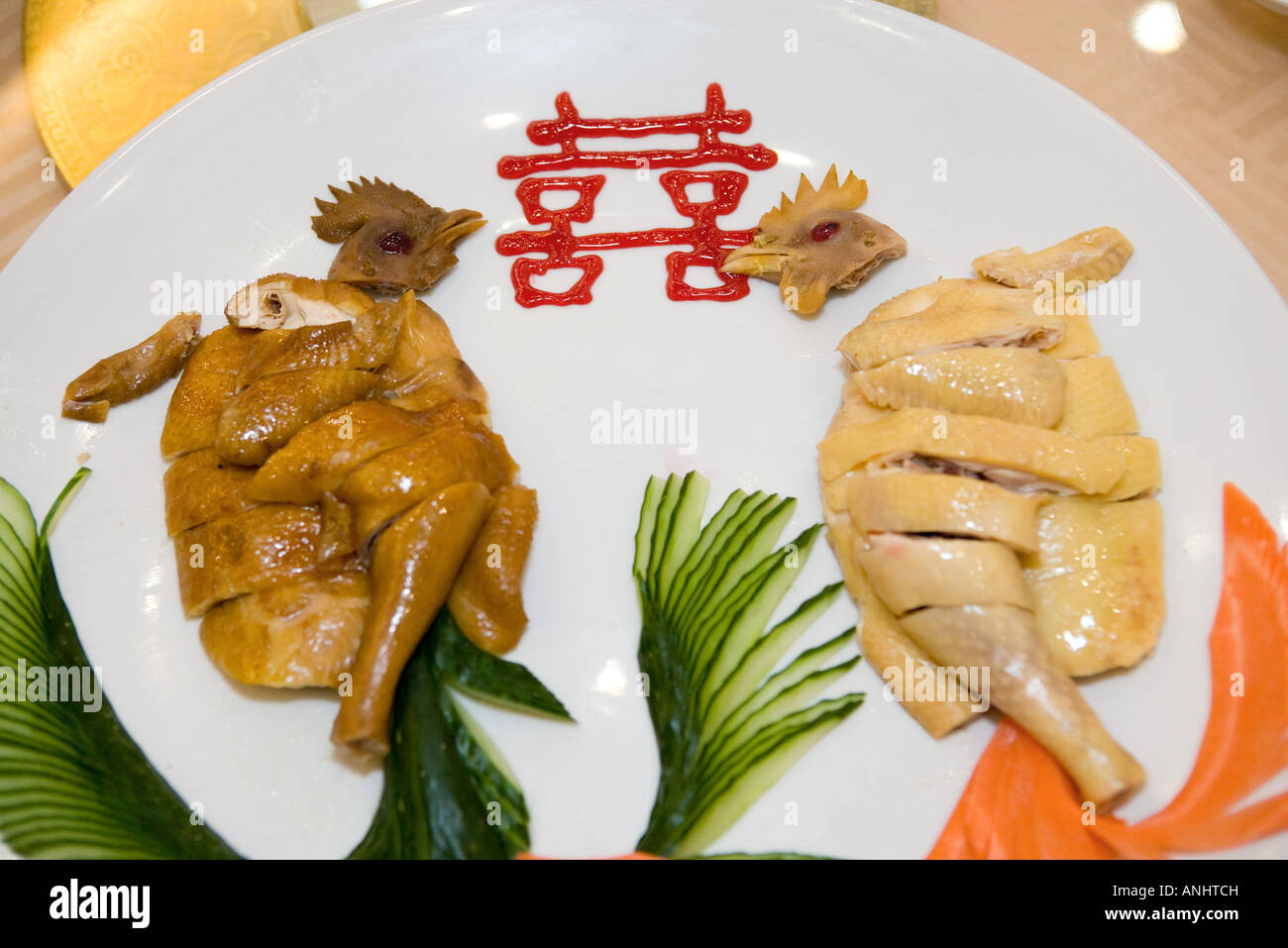 Close-up of cooked chickens on plate with Chinese ideogram Stock Photo