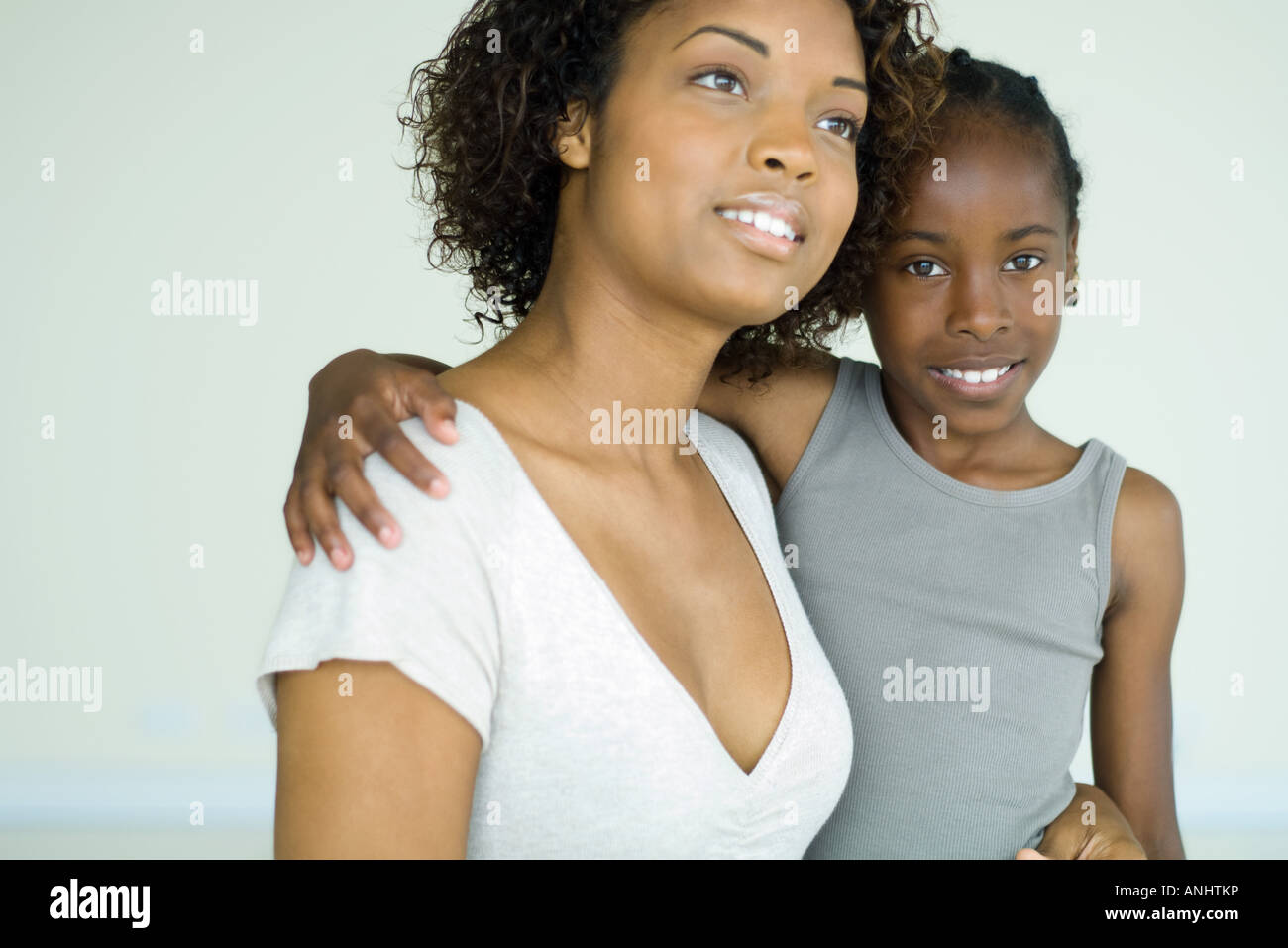 Mother holding daughter, both smiling, girl looking at camera Stock ...