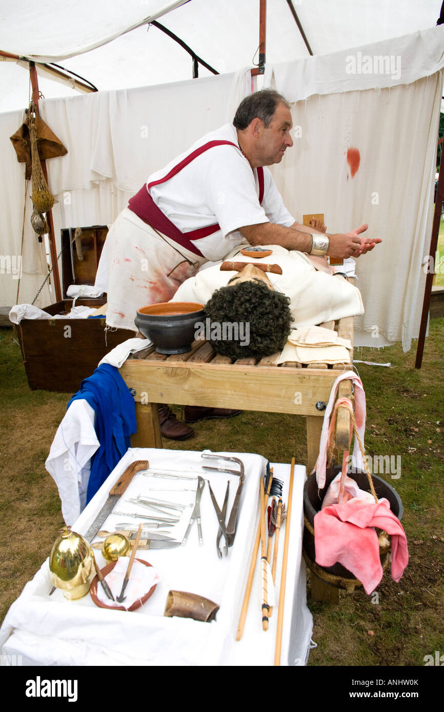 A reenactor dressed as a Roman surgeon or doctor at Chedworth Villa, Gloucestershire, UK Stock Photo