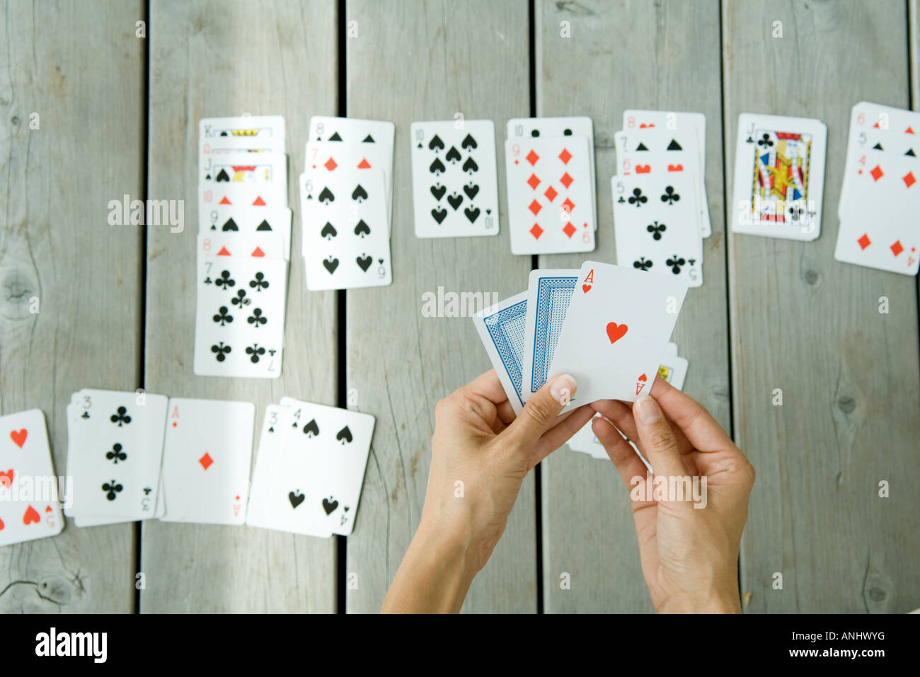 Woman Playing Solitaire Cropped View Of Hands And Cards Stock Photo Alamy