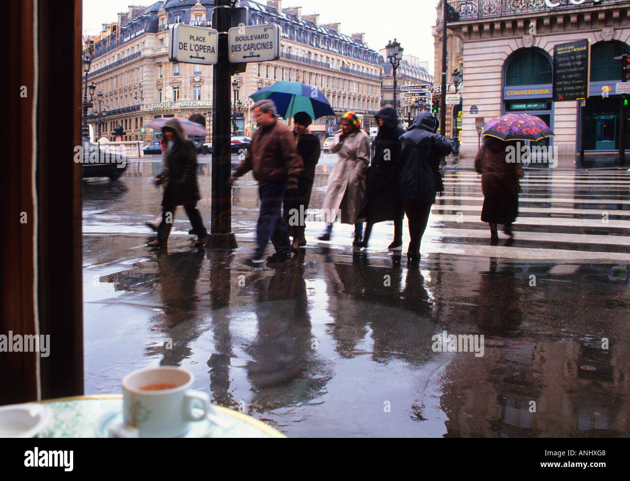 Paris Street Scene On A Rainy Day Looking Out Of A Cafe Window From Inside A Restaurant On The Right Bank People With Umbrellas Crossing The Street Stock Photo Alamy