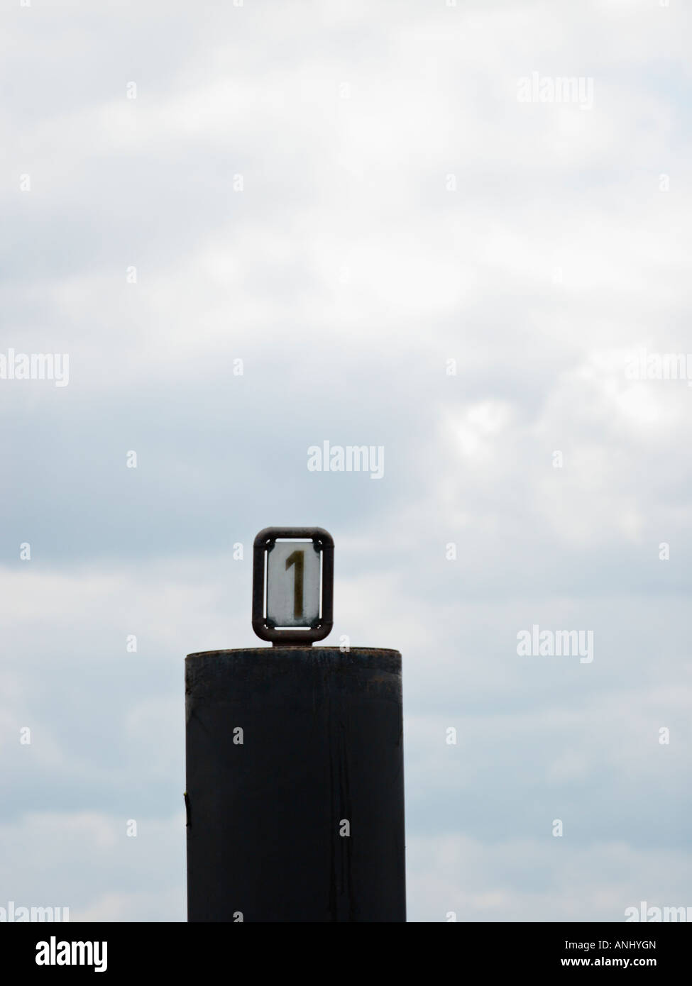 Number One sign on top of bollard Stock Photo