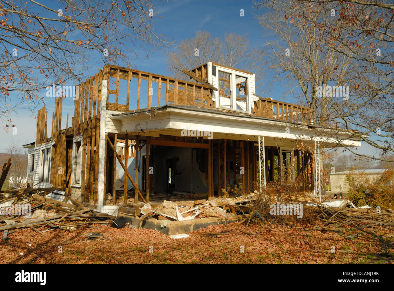 An old house is being torn down All that s left is the frame and lots of clutter Stock Photo