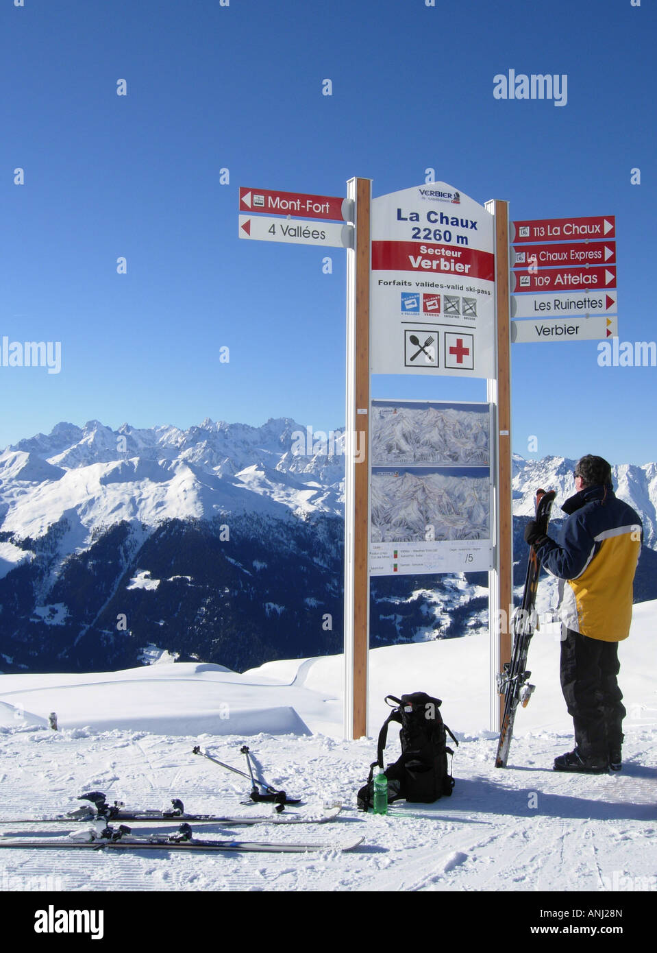 Skier checking the piste map at La Chaux on the slopes of Verbier ...