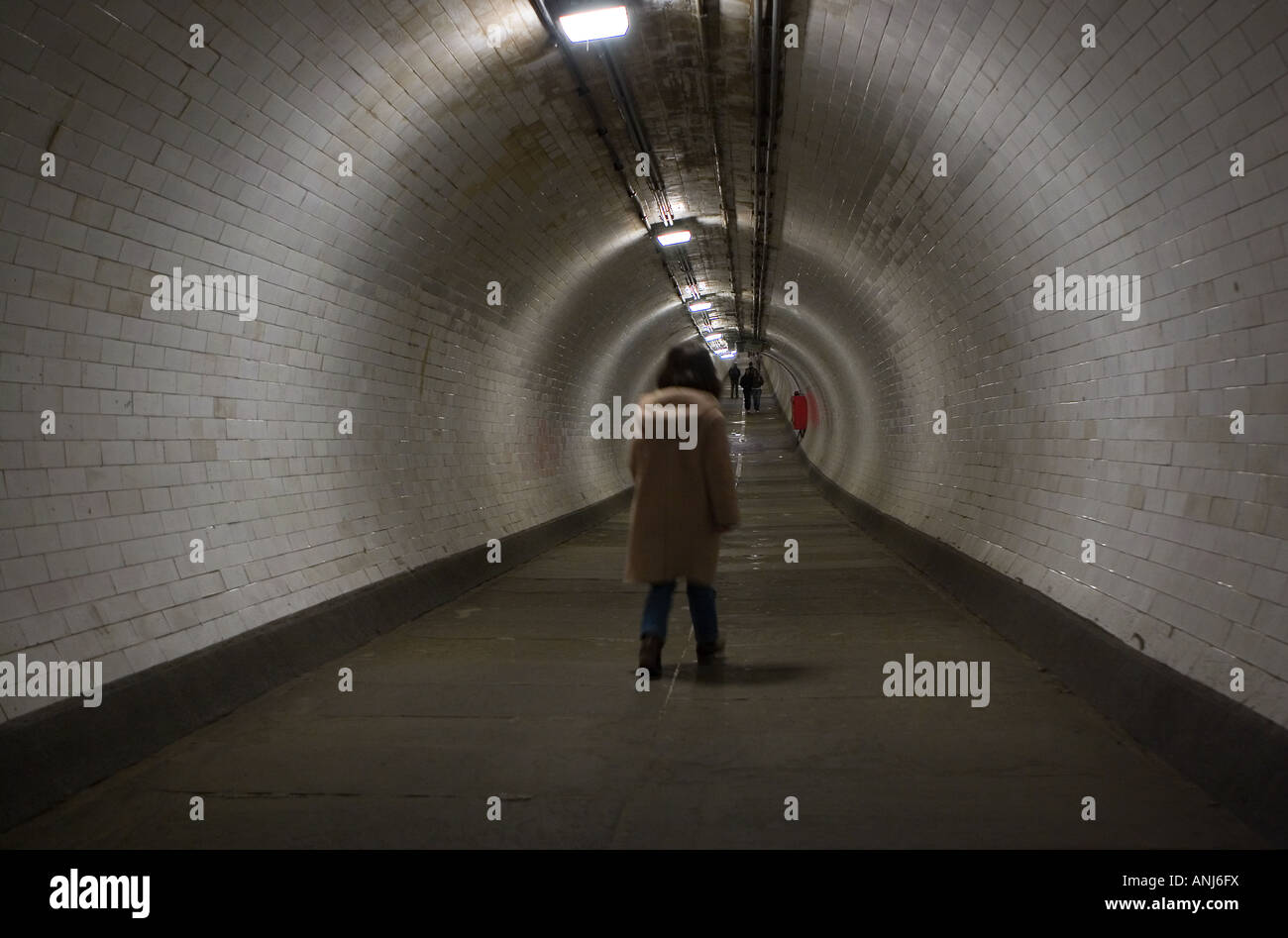 Little girl walks through the Thames Foot Tunnel from Greenwich to the Isle of Dogs in London Stock Photo